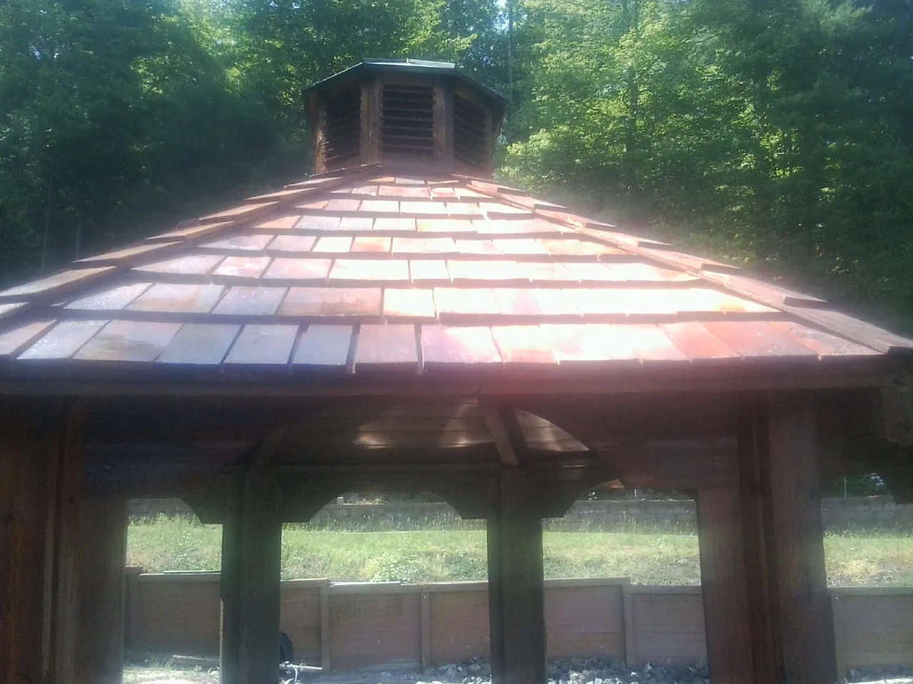 New cedar shake roof and cupola on a lakeside gazebo in Wellsburg