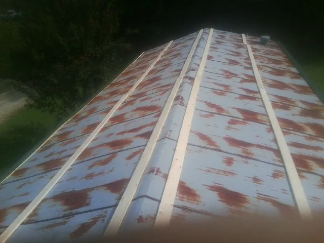 Rusted metal roof panels with new wood purlins before replacement — Storm Damage Roof Repair in Wellsburg by Roofing Brothers